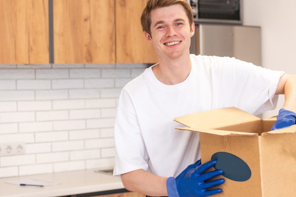 A professional mover packing office pantry items